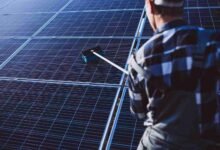 af man-worker-firld-by-solar-panels
