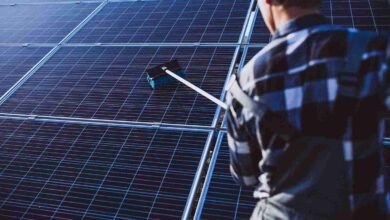 af man-worker-firld-by-solar-panels