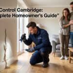 Professional termite control technician inspecting termite damage inside a modern home in Cambridge while concerned homeowners watch, highlighting expert termite control services and complete homeowner protection against termites.