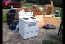 Appliance Removal Services Kent WA showing an old electric stove, furniture, and household junk placed curbside for professional appliance pickup and disposal.