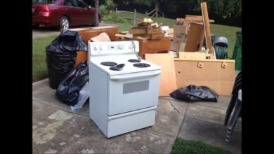 Appliance Removal Services Kent WA showing an old electric stove, furniture, and household junk placed curbside for professional appliance pickup and disposal.
