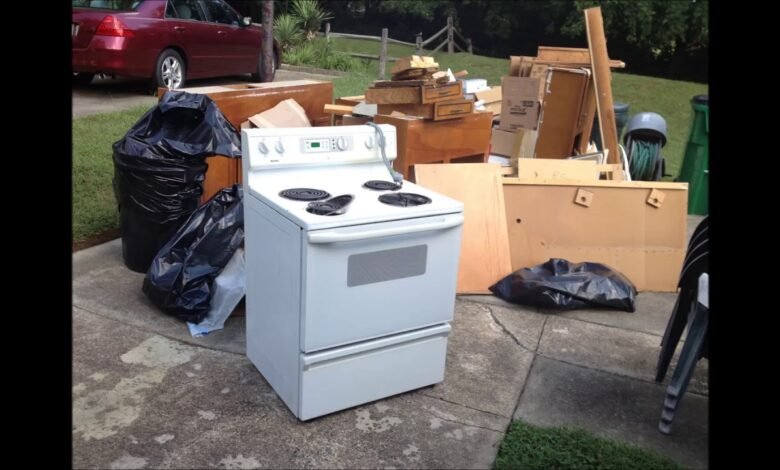 Appliance Removal Services Kent WA showing an old electric stove, furniture, and household junk placed curbside for professional appliance pickup and disposal.
